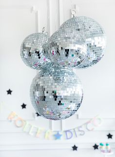 three shiny disco balls hanging from a ceiling