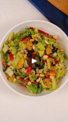 a salad in a white bowl on top of a table