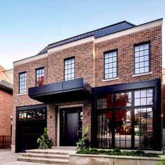 a brick house with black doors and windows