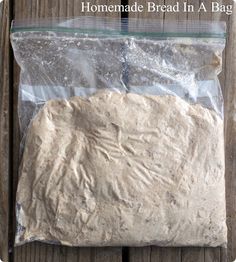 a bag filled with flour sitting on top of a wooden table next to a knife