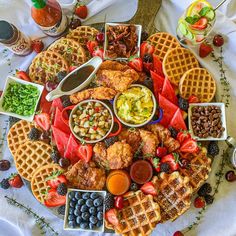 a platter filled with waffles, fruit and other foods