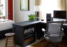 a bedroom with a bed, desk and computer