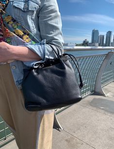 Editor's Notes: This mini bucket style handbag is made from soft pebbled Italian leather. It has a leather cord drawstring closure that secures all your essentials inside. The flat bottom adds spaciousness and makes it easy to find what you are looking for. The leather should strap sits comfortably on the shoulder. This is the perfect spring bag for your weekend getaways. Pebbled leather Drawstring closure Long leather strap included for a crossbody look Inside zipper pocket Two sewn in pockets Bucket Handbags, Spring Bags, Mini Bucket, Weekend Getaways, Leather Cord, Pale Blue, Leather Handle, Italian Leather, Pebbled Leather