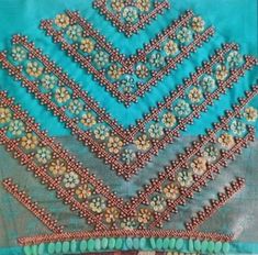 a close up of a piece of cloth with beaded designs on it and beads around the edges