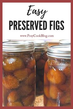 two jars filled with pickled fruit sitting on top of a wooden table next to each other