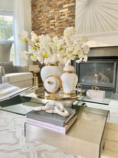 a living room filled with furniture and a fire place next to a fireplace covered in white flowers