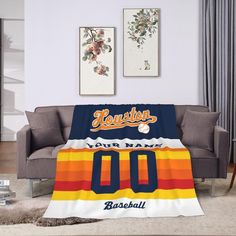 a baseball jersey blanket with the name and number on it in front of a couch