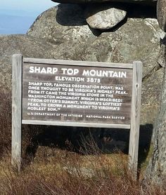 a sign on the side of a mountain stating sharp top mountain, elevation and information