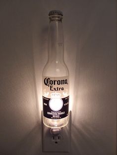 a light that is on the side of a wall with a beer bottle in it