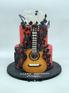 a red and black cake with a guitar on top