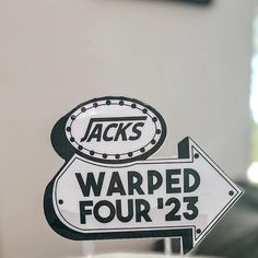 a white and black sign that says warped four's next to another sign with the word jack's on it