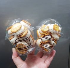 two plastic containers filled with cookies and pretzels sitting on top of each other