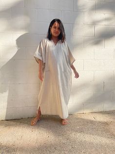 Flow in total comfort with our light cotton kaftan. This kaftan is perfect for the beach, pool, resort and laid-back time at home. Crafted from quality soft and light 100% cotton, it offers an airy fit that's ideal for lounging and out and about. Its relaxed design and easy slip-on style make it your go-to choice for outdoor happenings and relaxed nights at home. Relaxed Fit Beach Dress, Beachwear Kaftan With Short Sleeves In Relaxed Fit, Short Sleeve Relaxed Fit Kaftan For Beachwear, Beachwear Kaftan With Short Sleeve And Relaxed Fit, Summer Cotton Tunic For Loungewear, Beachwear Style Kaftan With Short Sleeves, Casual Summer Tunic Thobe, Casual Summer Thobe With V-neck, Casual V-neck Summer Thobe