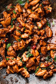 chicken and spinach stir frying in a wok with sauce on the side