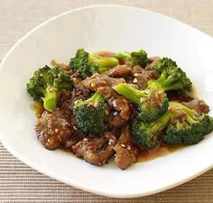 a white plate topped with meat and broccoli