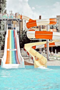 an inflatable water slide is next to a swimming pool