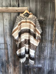 Native style alpaca/lambswool mix poncho Brown lambswool/alpaca wool poncho Etno style wool poncho very warm and breathable Blanket poncho One size fits fashionably for most everyone, short or tall, big or small. This piece is versatile for both Men's & Women's outdoor fashion, and can be used insider in cooler winter weather to keep warm while reading on the couch. CARE: Hand-wash and hang to dry, light iron if needed, or dry clean. MEASURES: Length at the front of the neckline to the botto Oversized Alpaca Poncho For Winter, Cozy Wool Poncho Cape, Handwoven Alpaca Poncho For Fall, Fall Handwoven Alpaca Poncho, Beige Alpaca Poncho One Size, Cozy Alpaca Poncho For Winter, Beige Alpaca Shawl Poncho, Winter Alpaca Poncho Cape, Beige Alpaca One-size Poncho