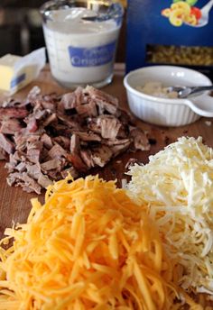 shredded cheese and other ingredients on a cutting board