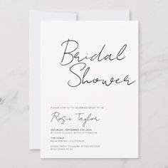 a white wedding shower card with the word bridal shower written in cursive ink