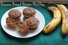 banana bread protein muffins on a white plate next to two bananas and a green cloth