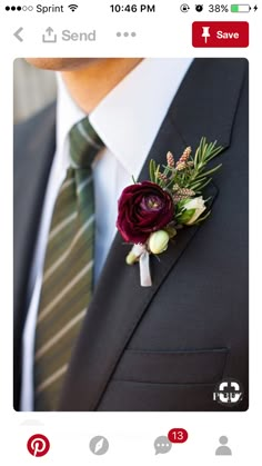 a man wearing a suit and tie with a boutonniere on his lapel