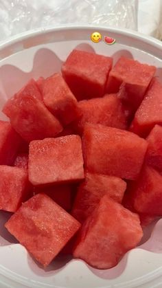 watermelon cubes in a white bowl on a table