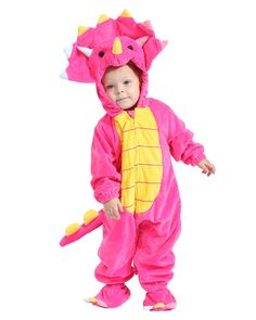 a child in a pink dragon costume standing on one leg and smiling at the camera