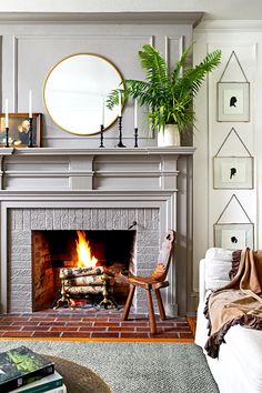 a living room filled with furniture and a fire place in the middle of the room