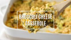 broccoli cheese casserole in a white dish with a wooden spoon over it