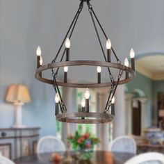 a wooden chandelier hanging over a dining room table