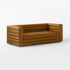 a brown couch sitting on top of a white floor