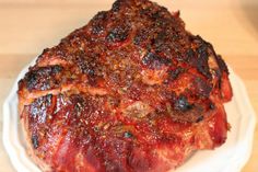 a piece of meat sitting on top of a white plate