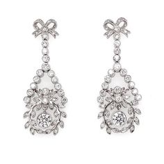 Handcrafted dangling platinum earrings with ribbon and floral motif. Accented with round diamonds 2.61 ct.  Diamonds are all natural and white in G-H Color Clarity VS.  Butterfly studs. Width: 1.5 cm Height: 4 cm Weight: 29.45 g  #maxjewelryinc #earrings #platinum #jewelry #diamonds #accessories #blingbling #luxury #fashion #vintageinspo #fashionjewelry #jewelryoftheday #contemporaryjewelry Luxury Silver Danglers With Intricate Design, Luxury Ornate Earrings With Diamond Accents, Luxury Diamond White Platinum Cluster Earrings, Ornate Silver Diamond Earrings, Luxury Flower-shaped Cluster Earrings With Diamond Accents, White Gold Hoop Earrings, Diamond Ribbon, Platinum Bracelet, White Gold Hoops