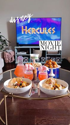 there is a tray with drinks and food on it in front of a tv that reads disney herculs movie night