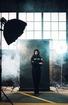 a woman standing in front of a photo studio