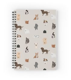 a spiral notebook with dogs and cats all over the page, on a light gray background