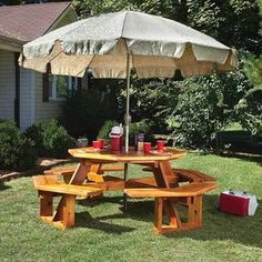 a picnic table with an umbrella in the backyard