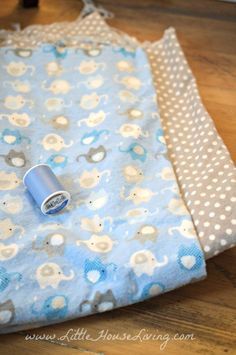 the blue and white fabric is laying next to each other on the wooden floor with polka dots