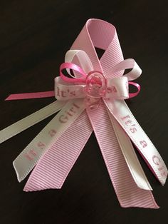 a pink ribbon with the words i miss you on it and a bow at the end