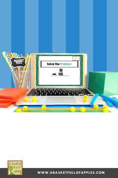 an open laptop computer sitting on top of a desk next to colorful pencils and markers