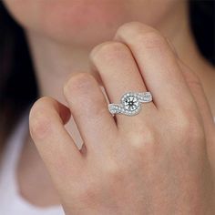 a woman's hand with a diamond ring on it