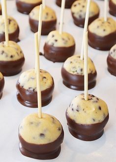 chocolate chip cookies and marshmallows are arranged on sticks