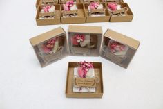 several small boxes filled with pink and white flowers