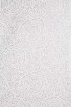 a white wallpaper with an intricate design on the front and back side of it