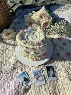 there is a cake on the table with flowers and pictures next to it, along with photos