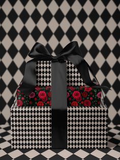 a black and white checkered box with red roses on it