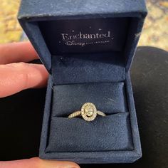 an engagement ring in a blue box with the word enchanted written on it