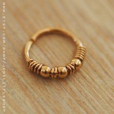 a gold ring sitting on top of a wooden table