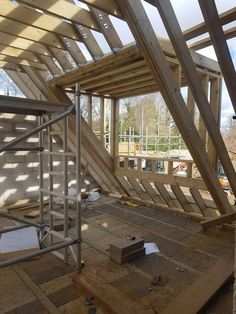 an unfinished attic with wood framing and metal bars