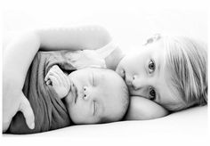 a black and white photo of two babies